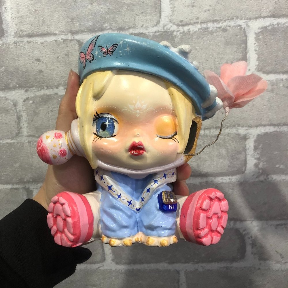 Colored doll figurine with butterfly motifs